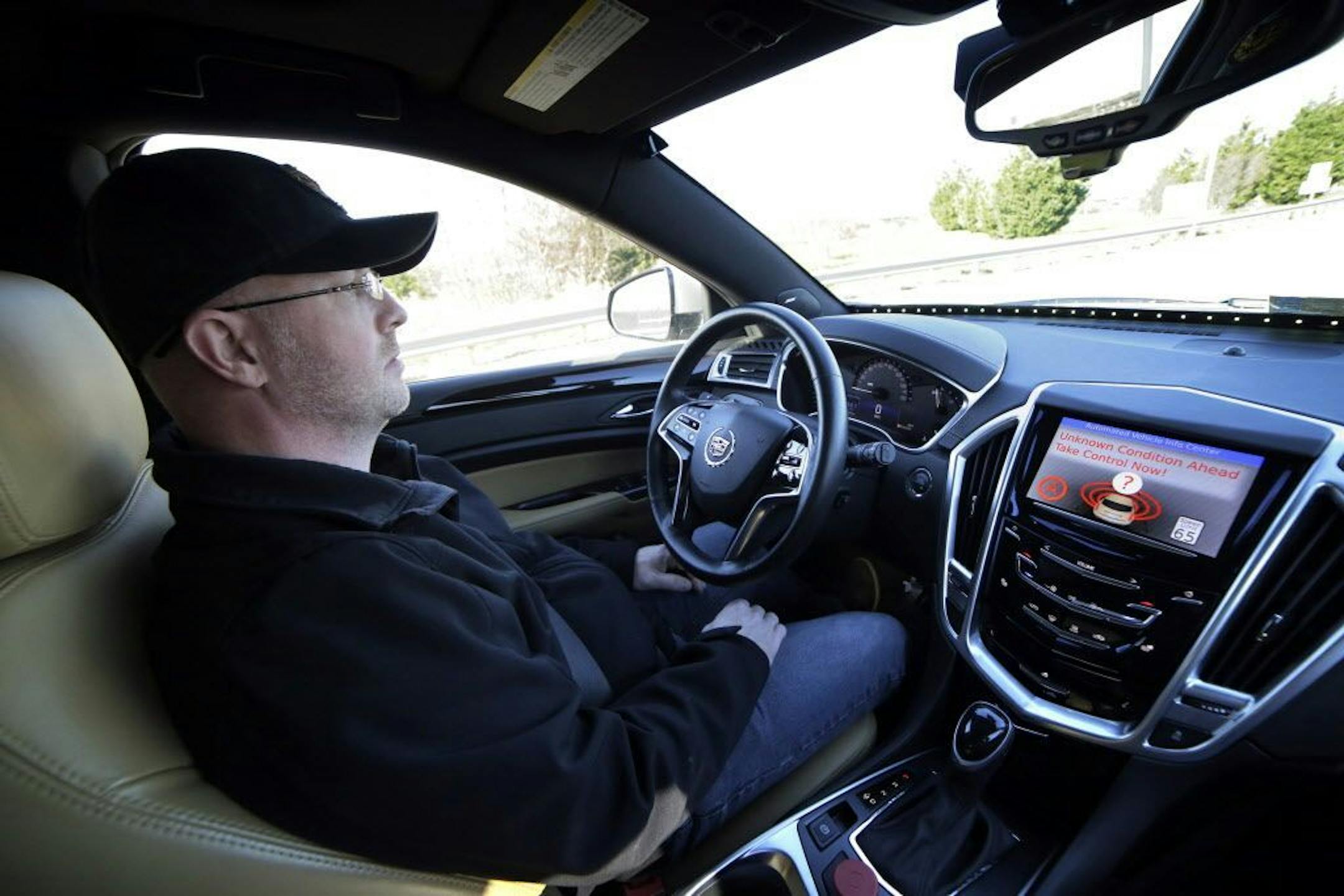 Virginia Tech Center for Technology Development's Greg Brown is behind the wheel of a driverless car during a test ride.