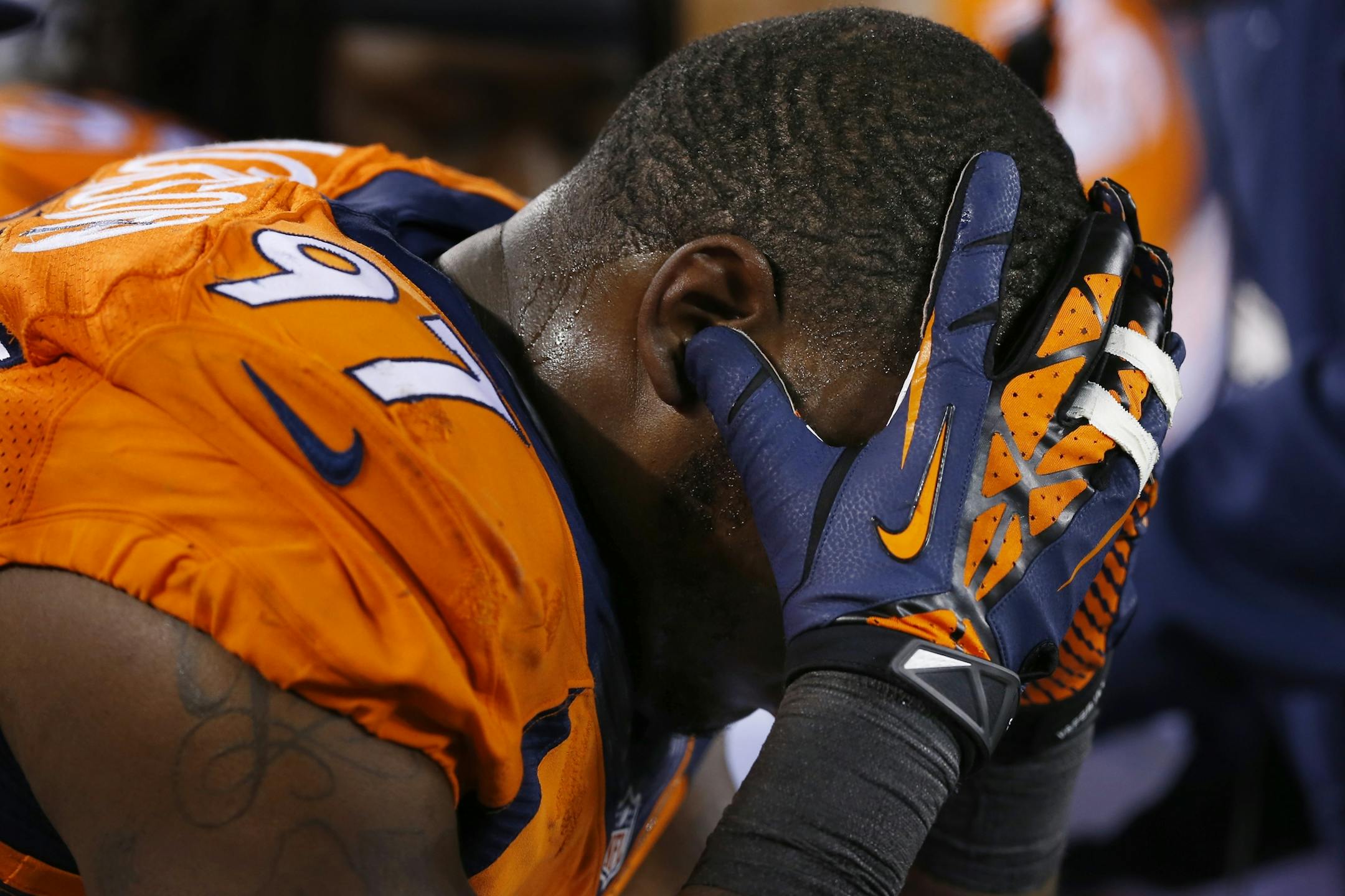 Denver Broncos' Malik Jackson cradles his head on the sidelines during the second half of the NFL Super Bowl XLVIII football game Sunday, Feb. 2, 2014, in East Rutherford, N.J. (AP Photo/Paul Sancya)