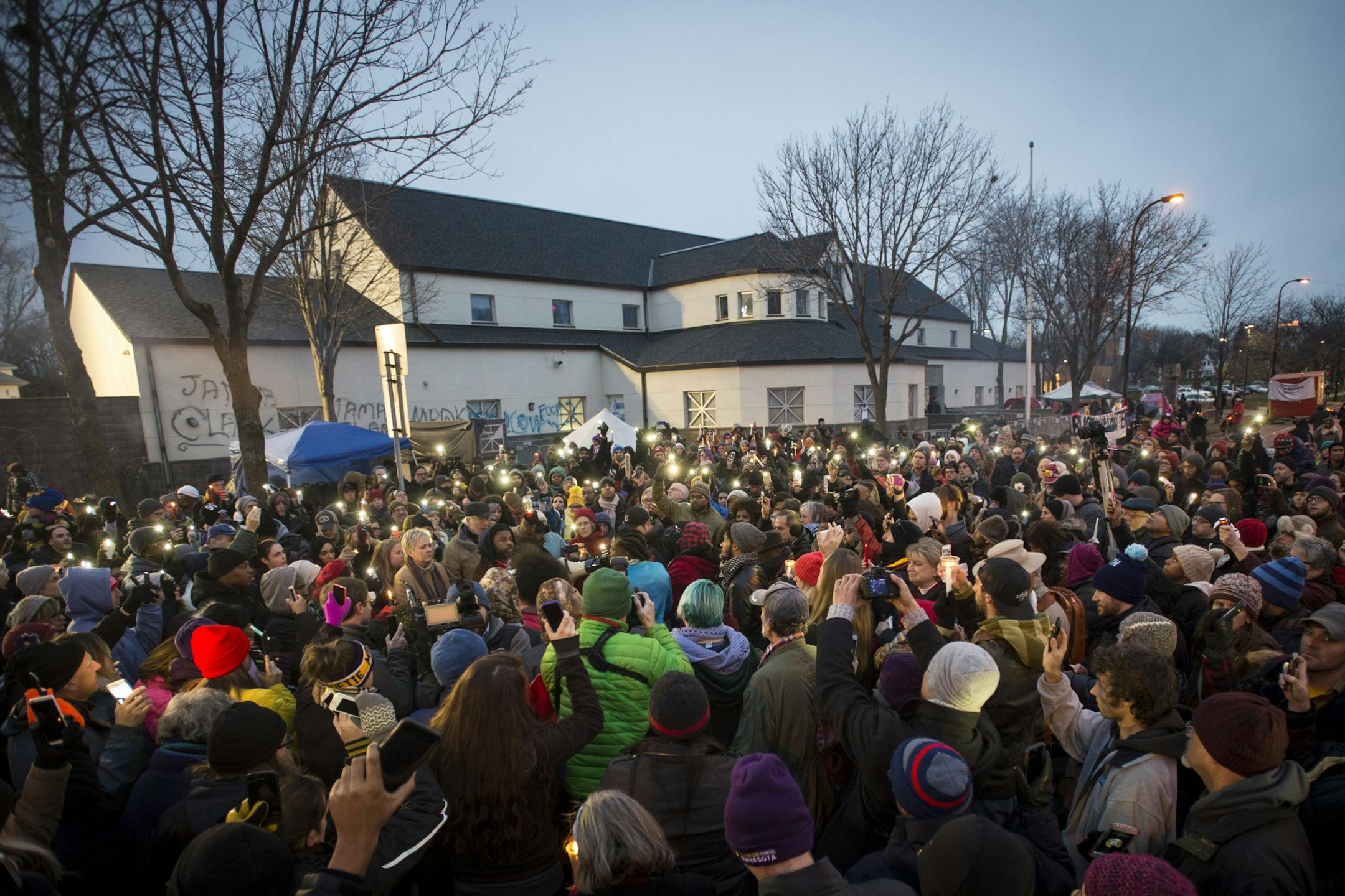 People participate in a candlelight vigil outside the Minneapolis Police Department 4th precinct building Friday, Nov. 20, 2015, in Minneapolis. The vigil was in response to the shooting death of Jamar Clark by police on Sunday. (Aaron Lavinsky/Star Tribune via AP) MANDATORY CREDIT; ST. PAUL PIONEER PRESS OUT; MAGS OUT; TWIN CITIES LOCAL TELEVISION OUT