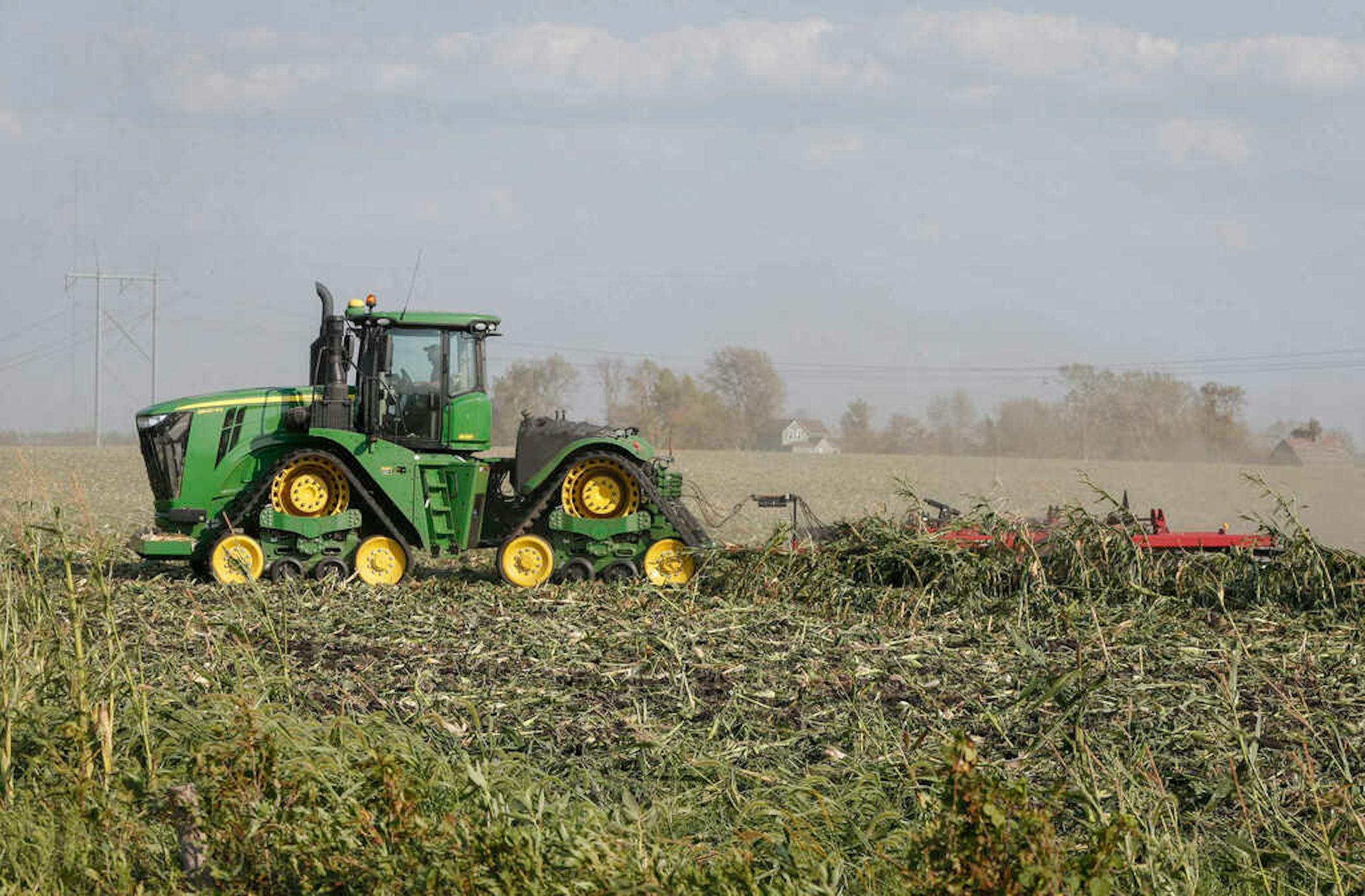Farmer Shawn Baker discs over a corn field on Wednesday, Aug. 26, 2020 at a farm north of Woodward, Iowa. The corn was damaged beyond salvage by the recent derecho.