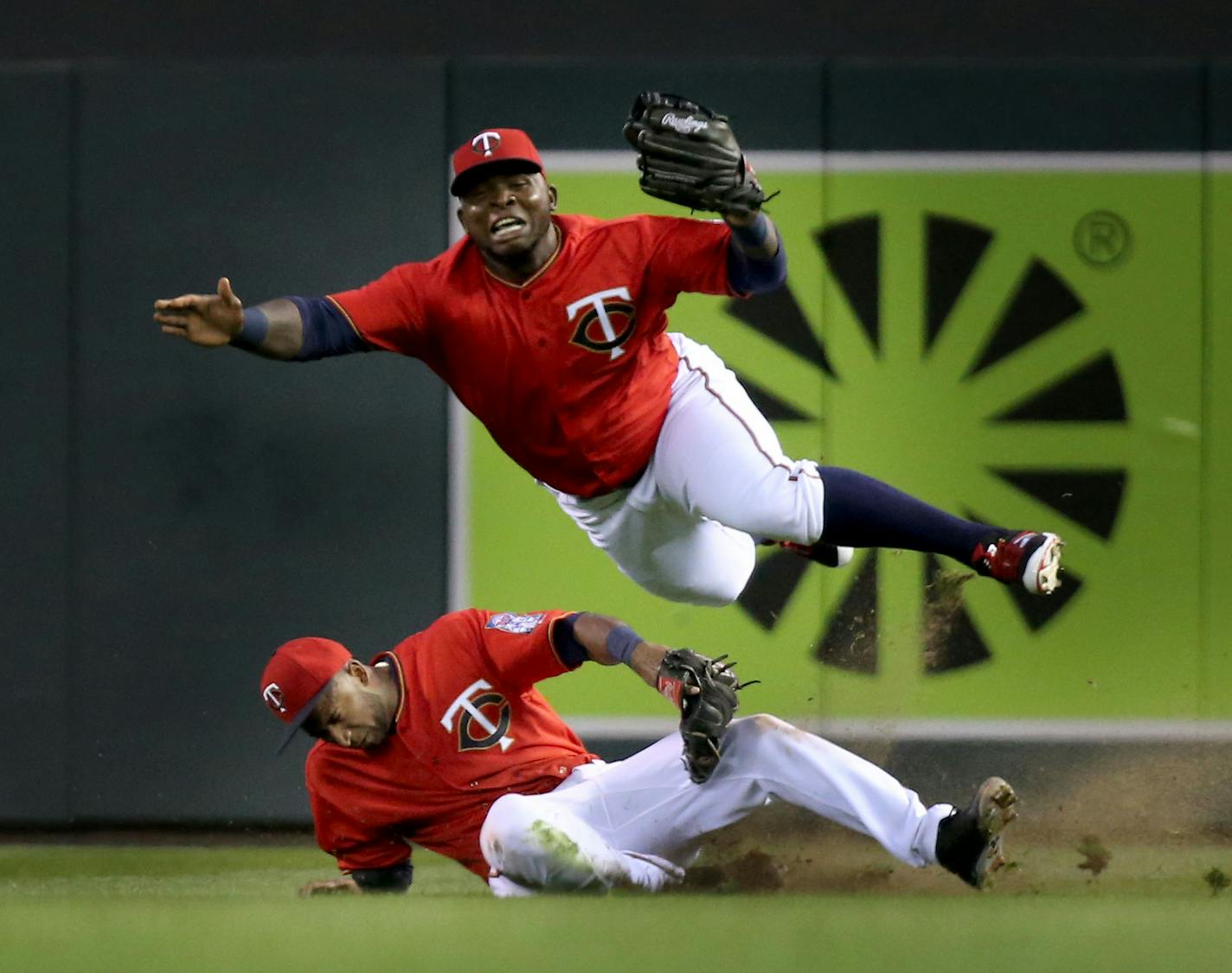 Minnesota Twins right fielder Miguel Sano, top, and second baseman Eduardo Nunez collide in right field while chasing a fly ball hit by the LA Angels Yunel Escobar who was thrown out at third base trying to stretch a double during the fourth inning Friday, April 15, 2016, at Target Field in Minneapolis, MN.](DAVID JOLES/STARTRIBUNE)djoles@startribune.com Minnesota Twins vs the LA Angels. It was Jackie Robinson at the ballpark for Major League teams across the country, with all players wearing nu