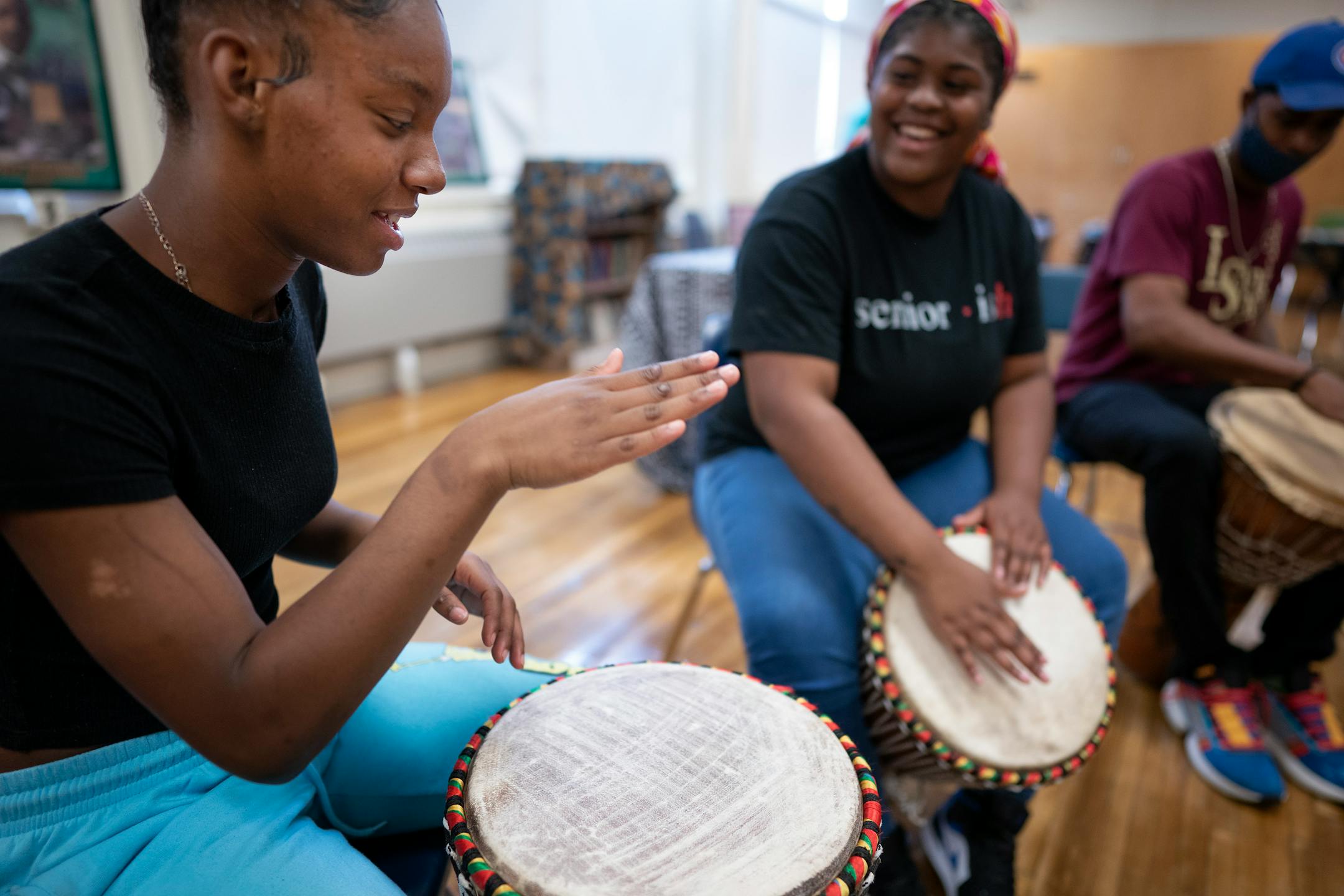 Ashantae Braxton center gave African drumming lessons to Denijah Johnson Washington left at Edison High School .