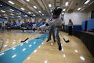 St. Cloud's Austin Iagred hits the puck away from his team's goal during the cognitively impaired adaptive floor hockey state tournament on Saturday, 