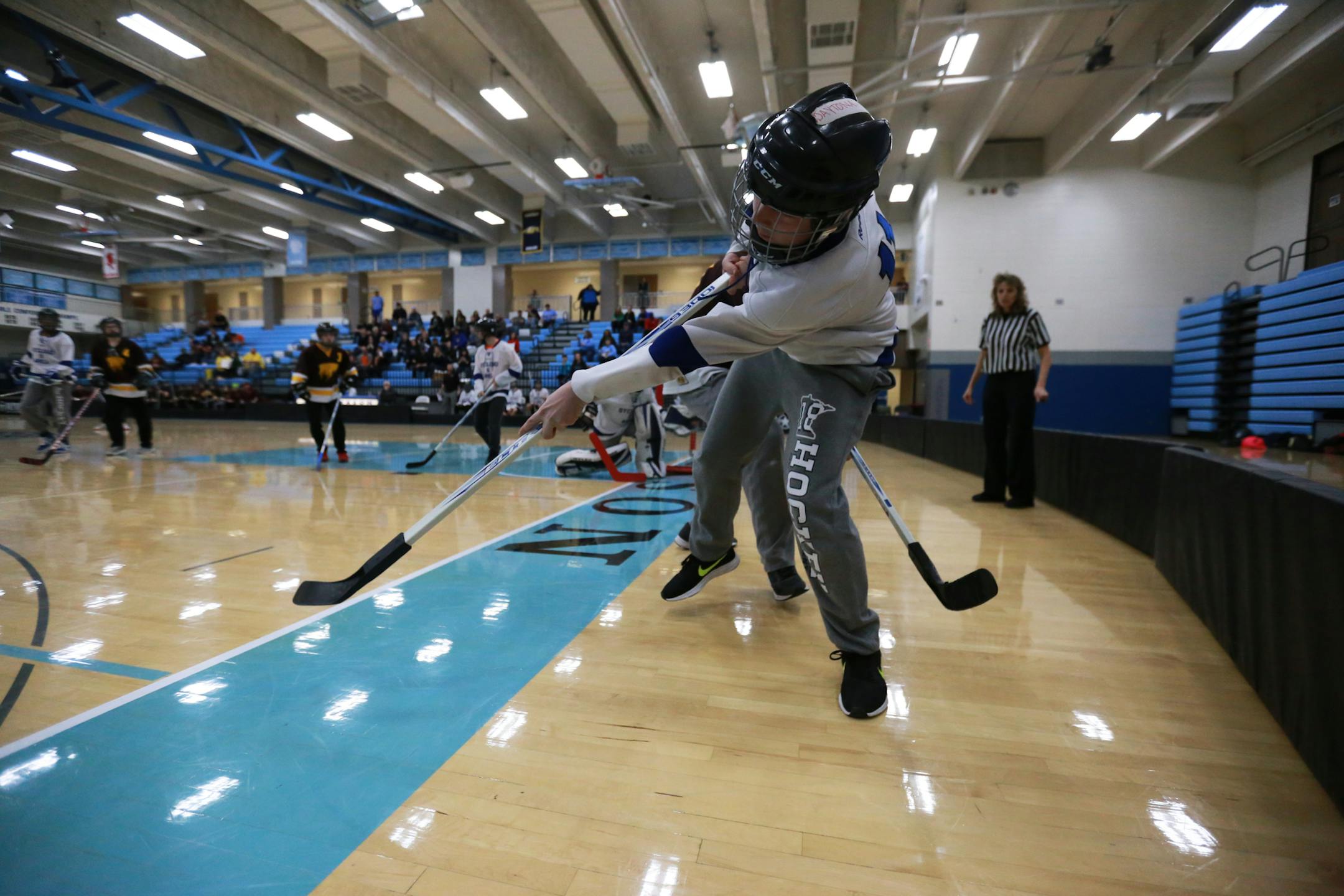 St. Cloud's Austin Iagred hits the puck away from his team's goal during the cognitively impaired adaptive floor hockey state tournament on Saturday, March 17, 2018 at Thomas Jefferson High School in Bloomington, Minn. [Ellen Schmidt ¥ ellen.schmidt@startribune.com