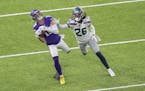 Minnesota Vikings' Adam Thielen (19) caught a 34-yard pass while defended by Seattle Seahawks' Shaquill griffin (26) in the first quarter.