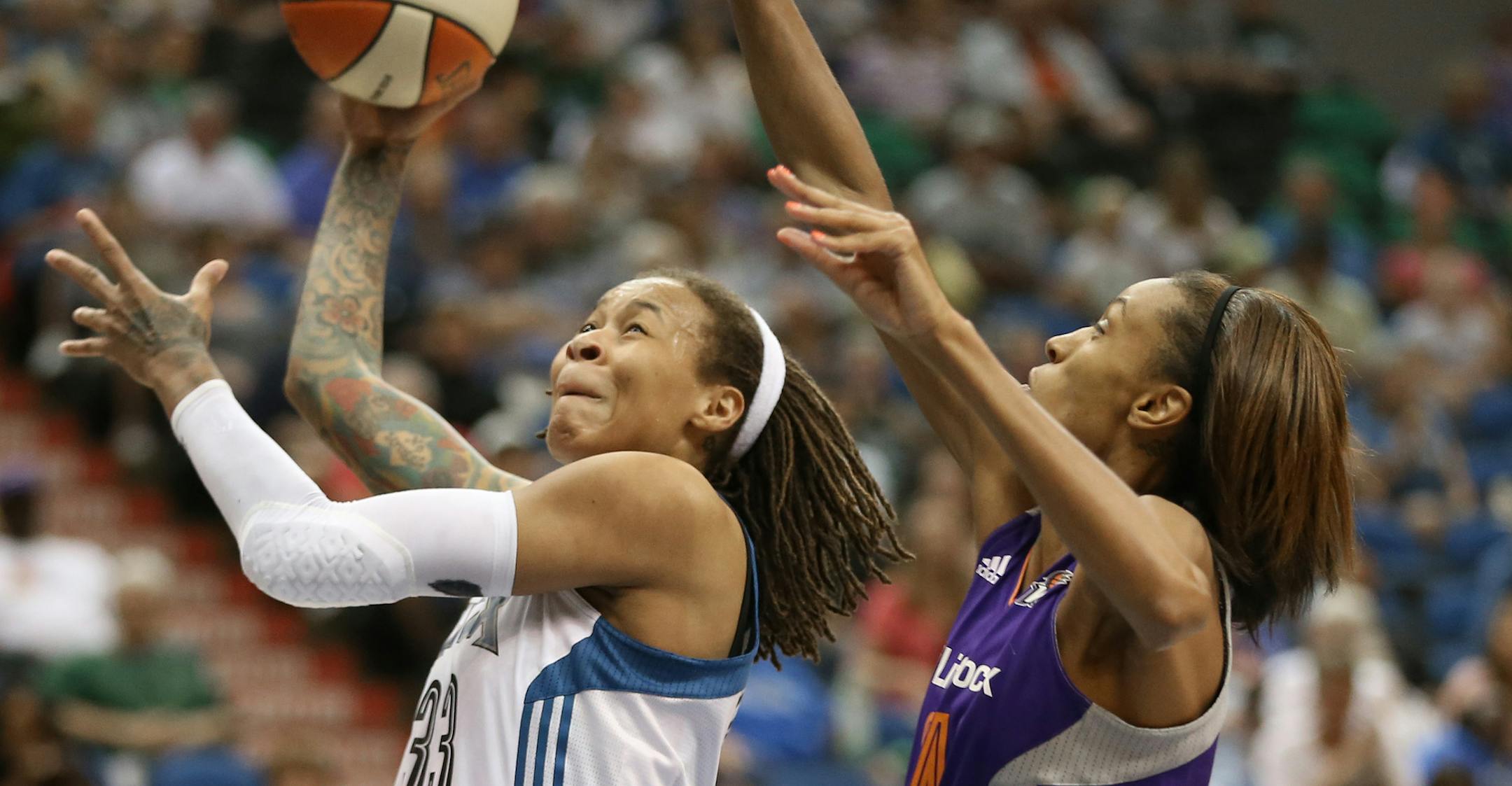 Minnesota Lynx vs Phoenix Mercury, Target Center, Minneapolis, MN., 7/24/13. (left to right) Minnesota's Seimone Augustus drove to the basket as she was defended by Phoenix's DeWanna Bonner in 1st half action.] Bruce Bisping/Star Tribune bbisping@startribune.com Seimone Augustus, DeWanna Bonner/roster.