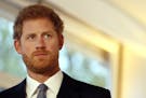 Britain's Prince Harry stands by a sign as he watches a short film at an International Mine Awareness Day reception at Kensington Palace in London, Tu