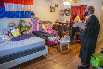 Judge Donovan Frank, right, gave a private citizenship ceremony to Aung Myat, left, and Bway Paw, center, with help from their son Way Htoo, at their 