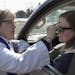 Pastor Christine Chiles put a cross on the forehead of Noreen Faulkner of Plymouth during a drive through service of Ash Wednesday March 1, 2017 in at