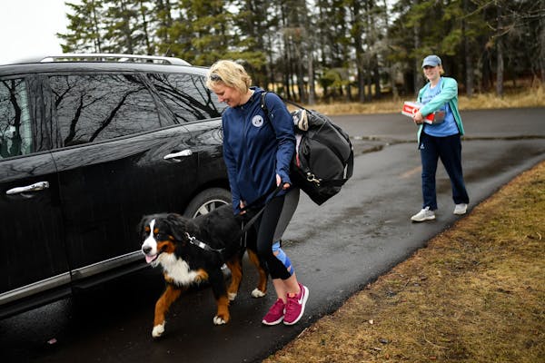 Kelli Briggs and her daughter, Gabby Shaul, 17, brought their belongings inside their home along with their Bernese mountain dog, Koda, 4, Friday morn