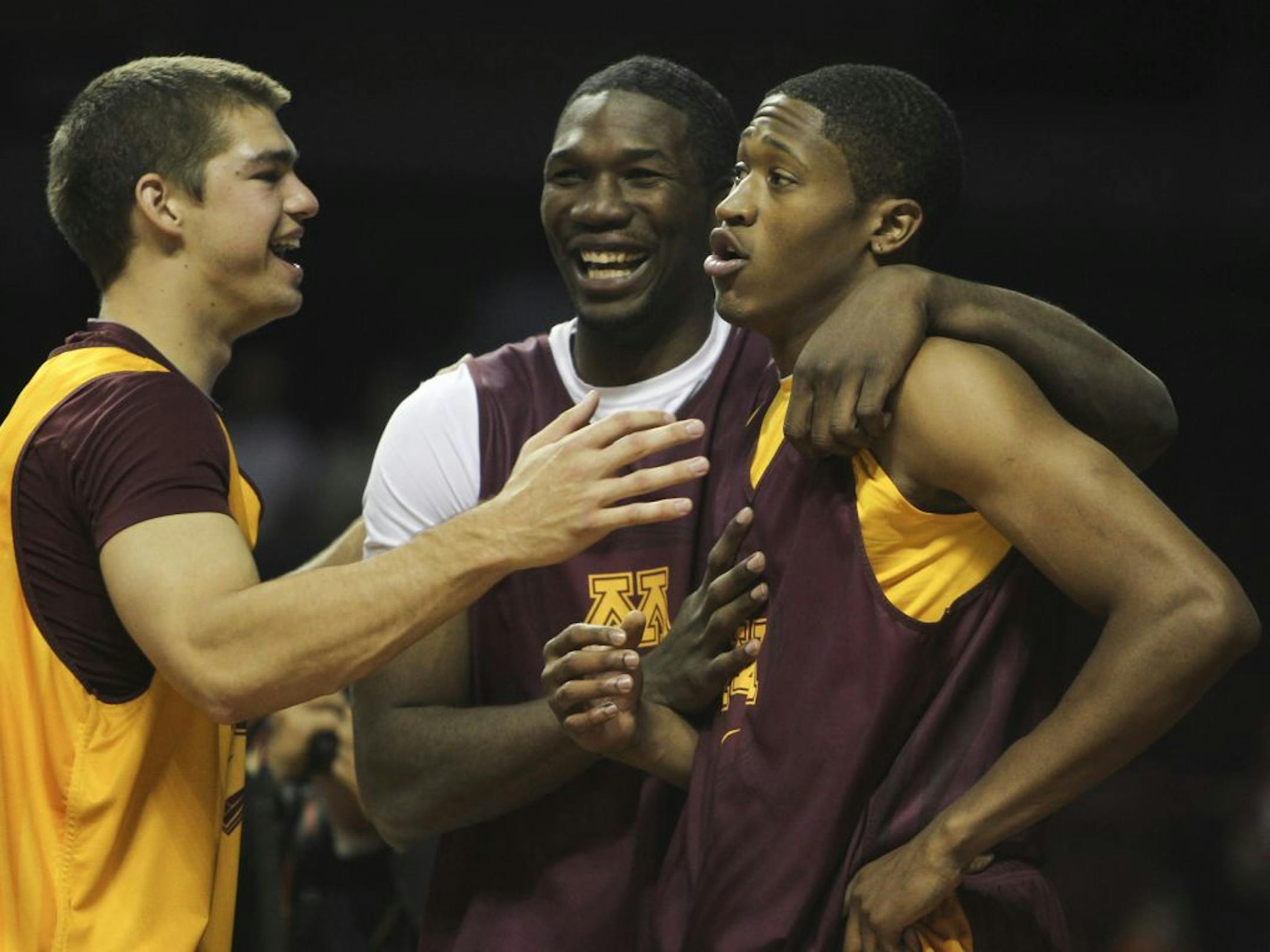 The Gophers Rodney Williams, right, is greeted by teammates Trevor Mbakwe, center, and Chris Halvorsen, left, after winning the dunk contest as the University of Minnesota men's basketball took the floor for the first time in a scrimmage Friday, Oct. 12, 2012, at Williams Arena in Minneapolis, MN.