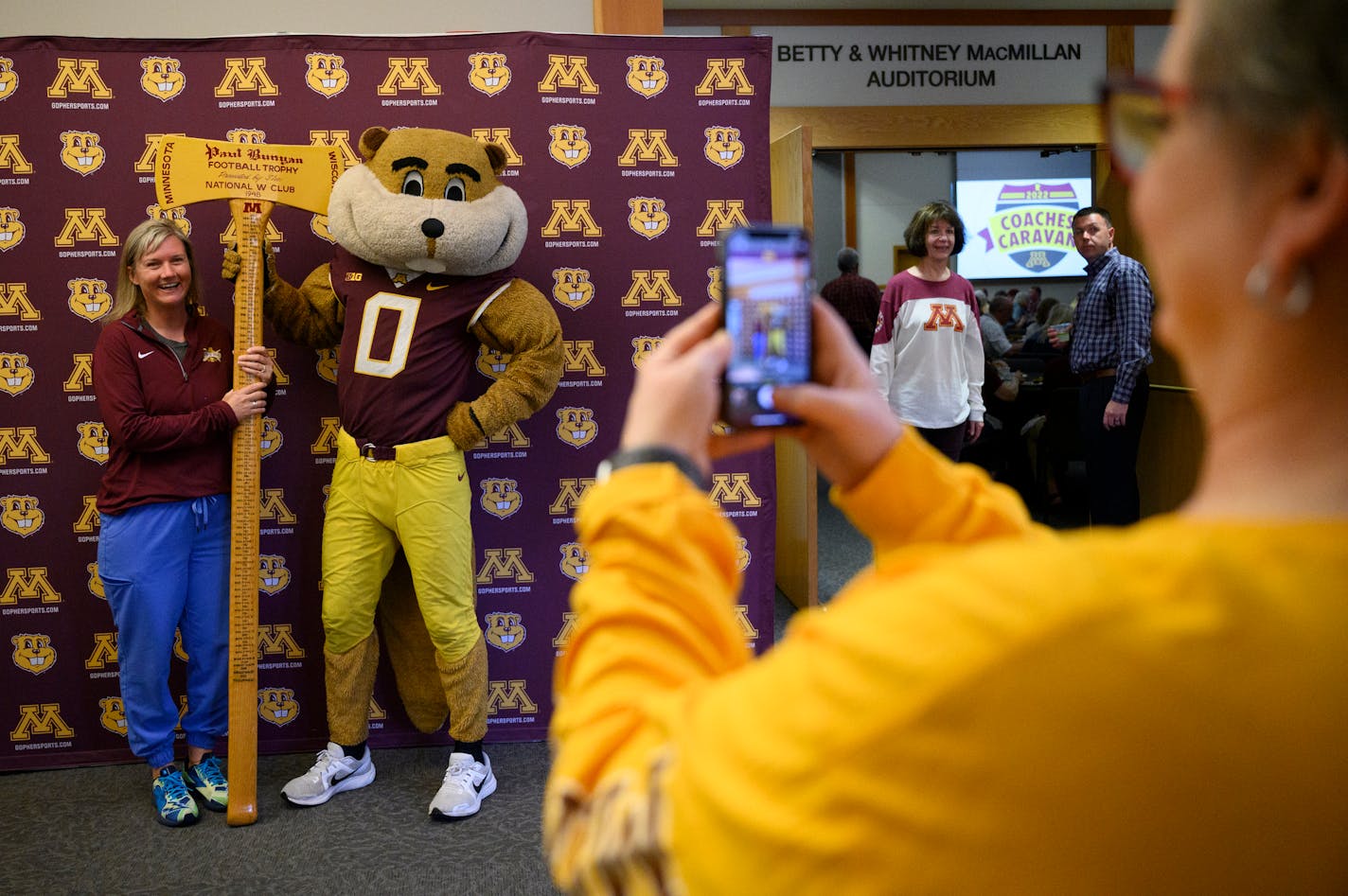 Jenni Morrison, of White Bear Lake, poses for a photo with Goldy Gophers as they hold Paul Bunyan's Axe, won during last season's football victory over Wisconsin, during the University of Minnesota Coaches Caravan Monday, May 9, 2022 at the Minnesota Landscape Arboretum in Chaska, Minn.. ] AARON LAVINSKY• Aaron.lavinsky@startribune.com