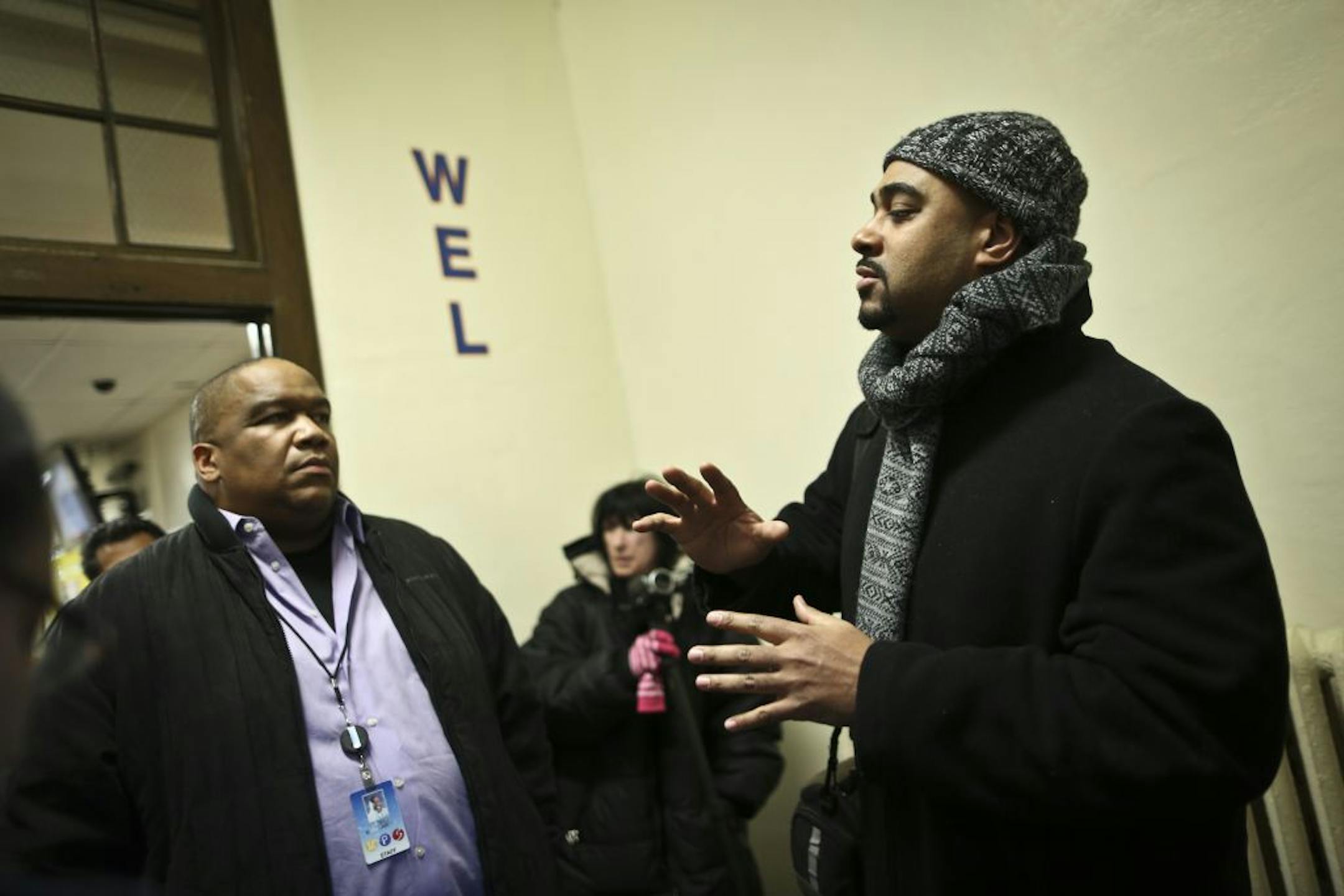 Parent Ralph Crowder, right, said parents should have been told of the incident sooner. James Burroughs, the district's executive director of equity and diversity, is at left.