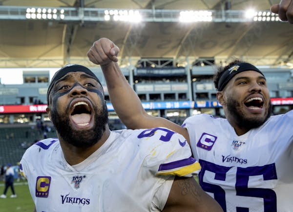 Minnesota Vikings' Everson Griffen (97) and Anthony Barr (55) celebrated at the end of the game.