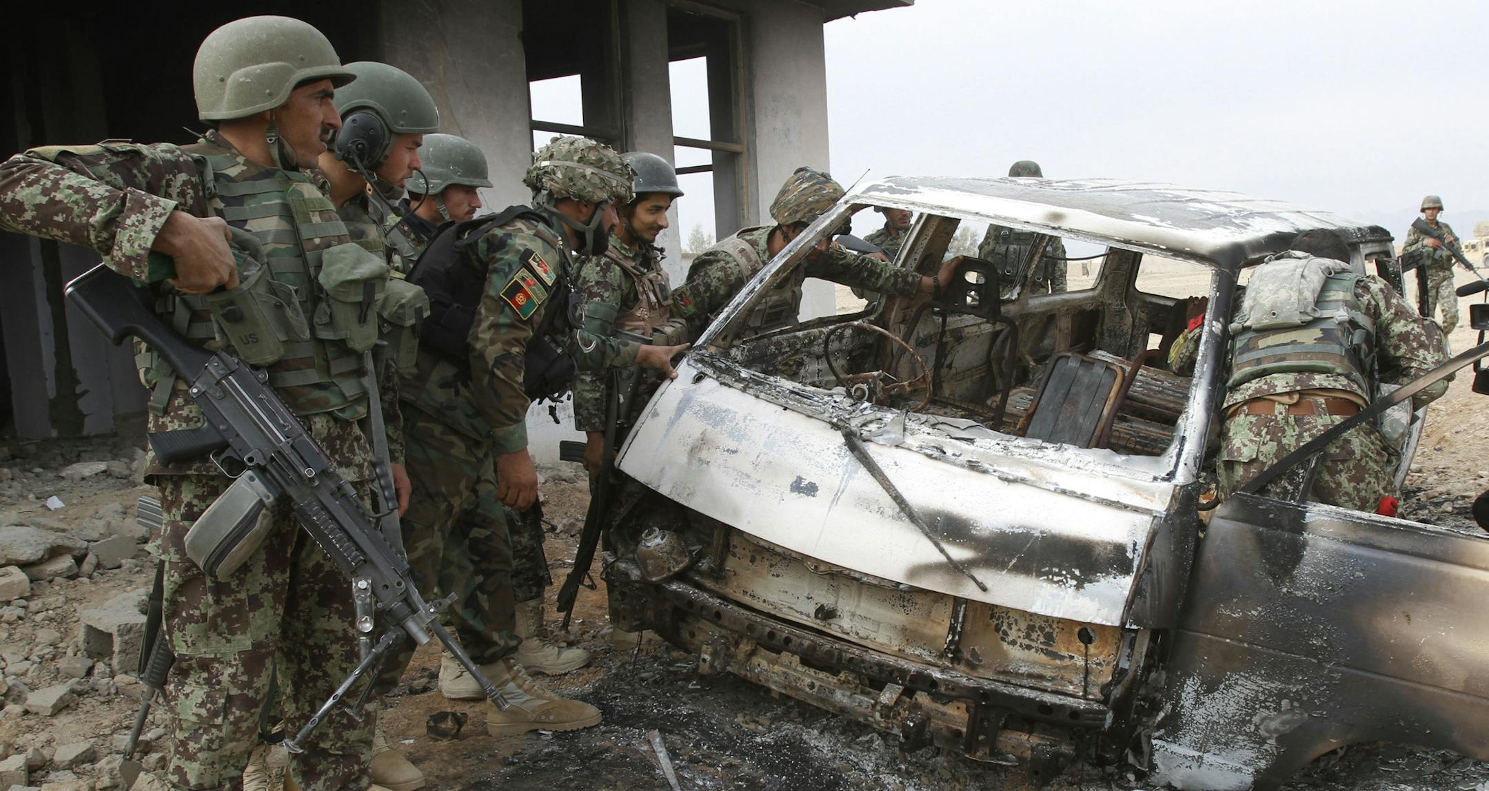 Afghan soldiers investigated the remains of a suicide bomber’s vehicle at a NATO base west of Kandahar city on Monday.