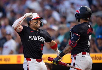 Twins third base Royce Lewis celebrates hitting a two run homer with shortstop Carlos Correa (4) in the eighth inning.