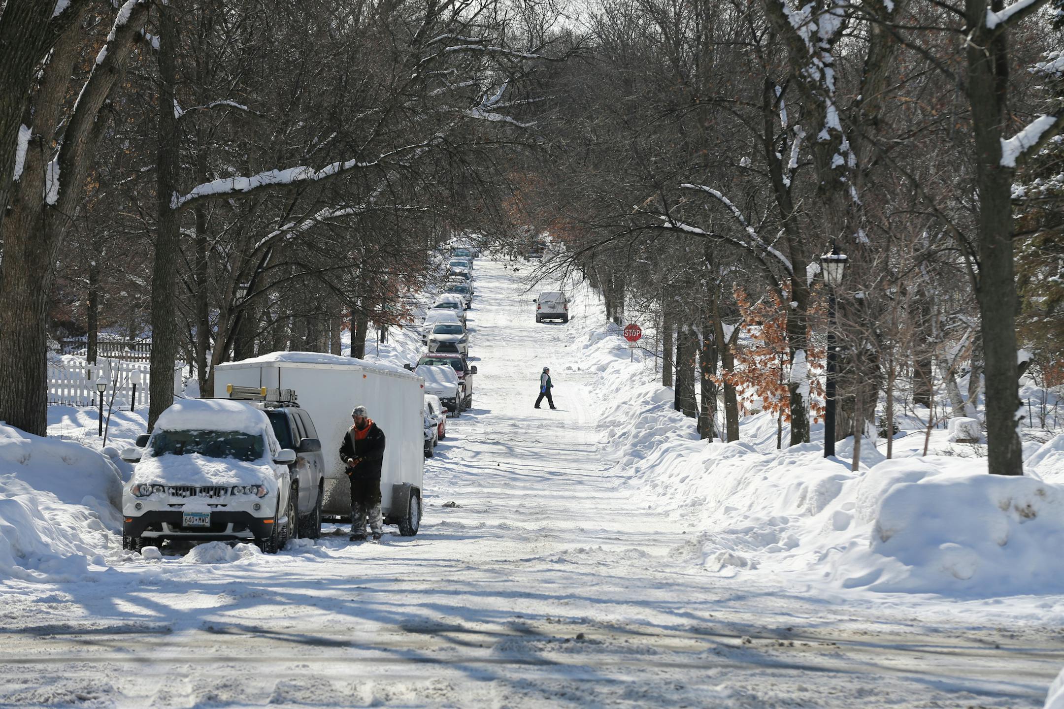 A pedestrian walked across Girard Ave. S. in Minneapolis on Wednesday, Feb. 27, 2019. The even (right) side of the street didn't have many cars parked on it after the city imposed parking restrictions scheduled until April 1 so crews can remove snow and widen the street so emergency vehicles can pass. ] Shari L. Gross &#x2022; shari.gross@startribune.com The city of Minneapolis has imposed a parking restriction on the even side of streets so snow can be removed. The restriction is scheduled to l