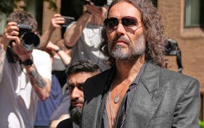 English comedian and actor Russell Brand leaves Southwark Crown Court where he is charged with rape and sexual assault in London, Friday, May 30, 2025