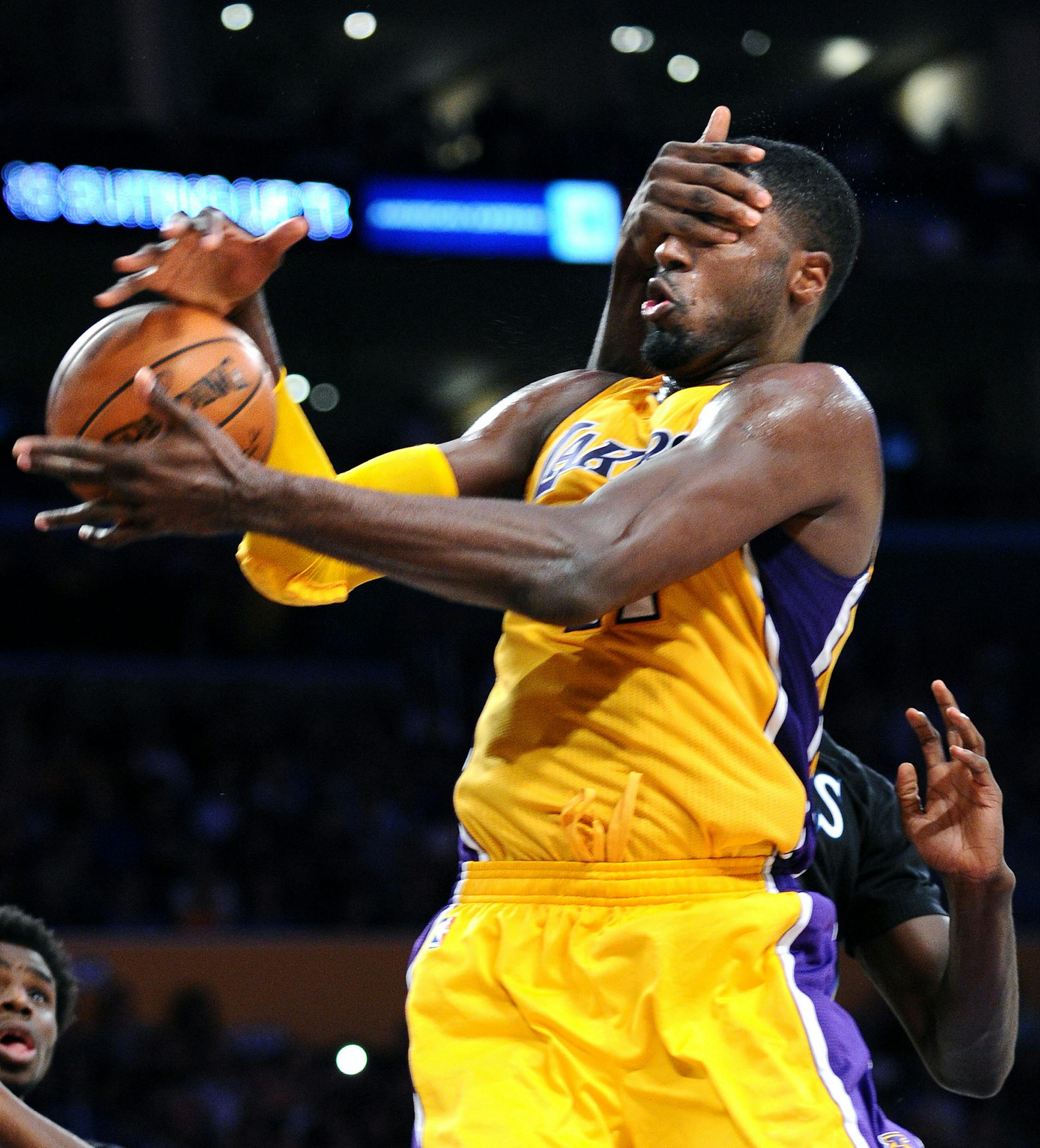 The Los Angeles Lakers' Roy Hibbert is hit in the face as he is fouled by the Minnesota Timberwolves' Gorgui Dieng, rear, in the third quarter at Staples Center in Los Angeles on Wednesday, Oct. 28, 2015. (Wally Skalij/Los Angeles Times/TNS)