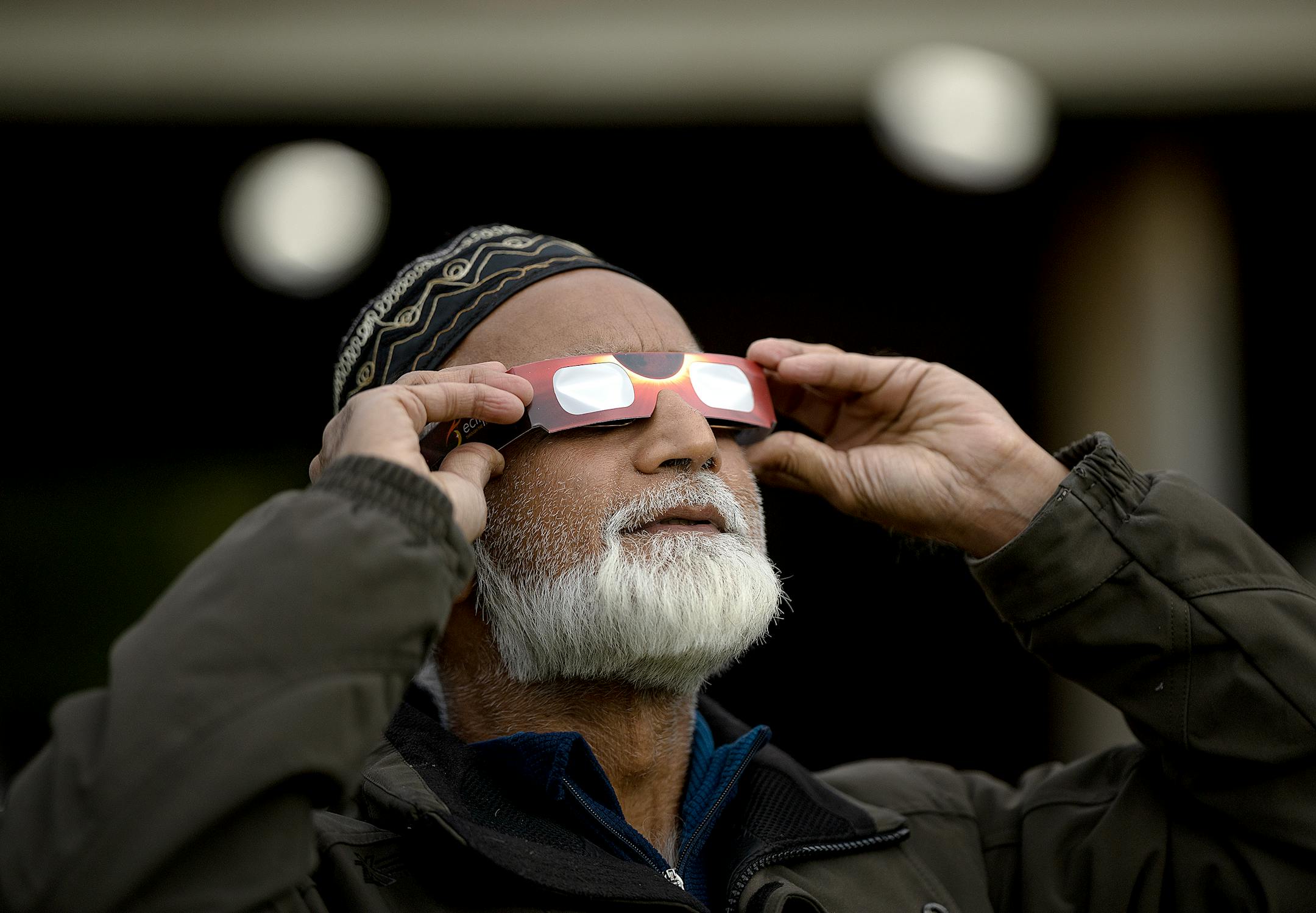"It's a sign from God," said Abdulla Mandani, cq, as he views the annular Eclipse during a viewing party at Commons Park in Fridley, Minn., on Saturday, Oct. 14, 2023.