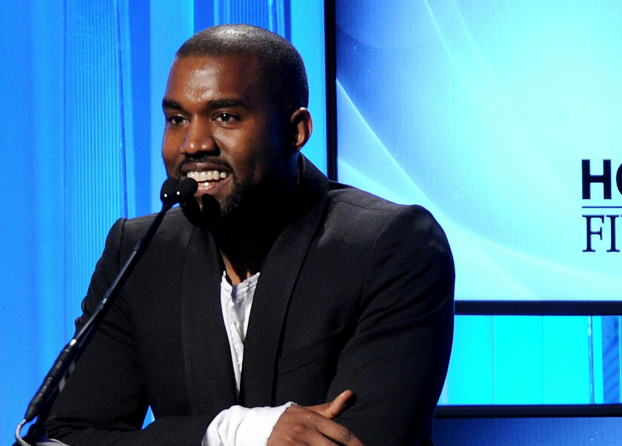 FILE - In this Oct. 22, 2013 file photo, recording artist Kanye West speaks onstage during the 17th Annual Hollywood Film Awards Gala at the Beverly Hilton Hotel in Beverly Hills, Calif. The rapper-producer has postponed his May tour of Australia so he can concentrate on new music. West announced Tuesday, April 1, 2014, that he'll postpone seven dates in five cities scheduled for May 2-11 dates to Sept. 5-15 because of "unexpected timing requirements" to finish his new album, expected to be rele