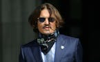 Actor Johnny Depp arrives at the High Court for a hearing in his libel case, in London, Friday, July 24, 2020.