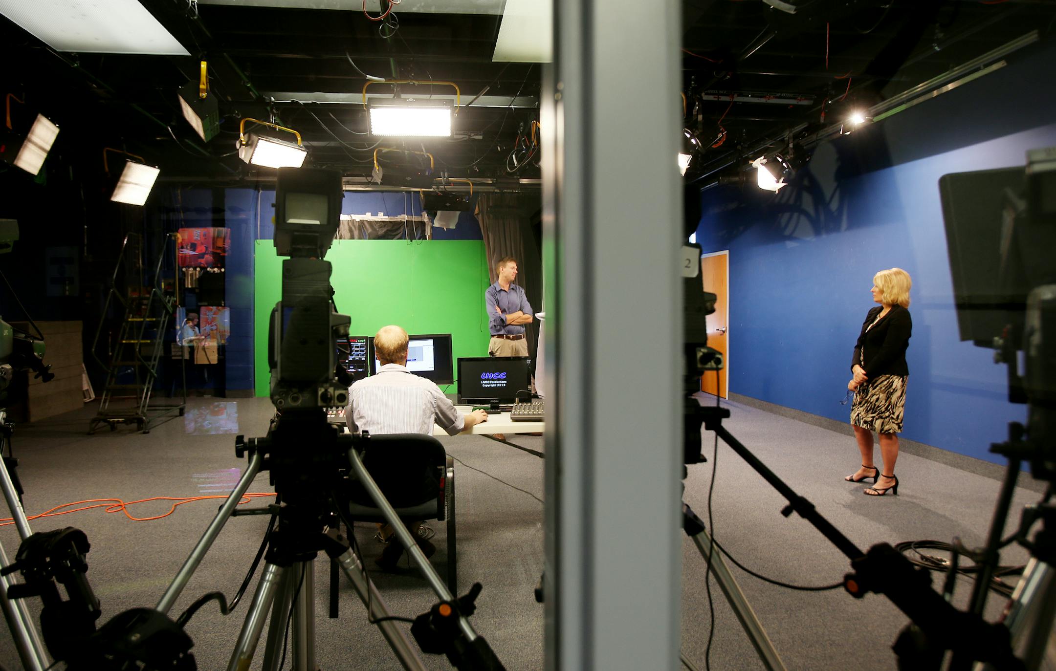 Tyler Rabe (left) and Production Manager Chris Vogt (center) and Executive Director Sally Koenecketest equipment in the studio of the Lake Minnetonka Cable Commission in Spring Park, MN on October 7, 2013. ] JOELKOYAMA‚Ä¢joel koyama@startribune