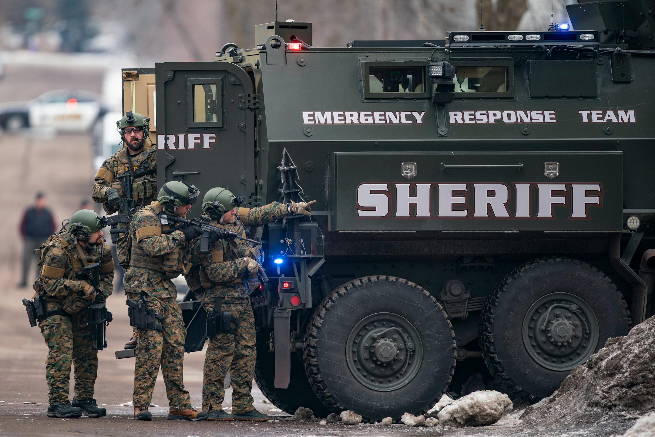 St. Louis County sheriffs were armed with rifles and grenade launchers as they maintained a perimeter and attempted to force the gunman out of his house.
