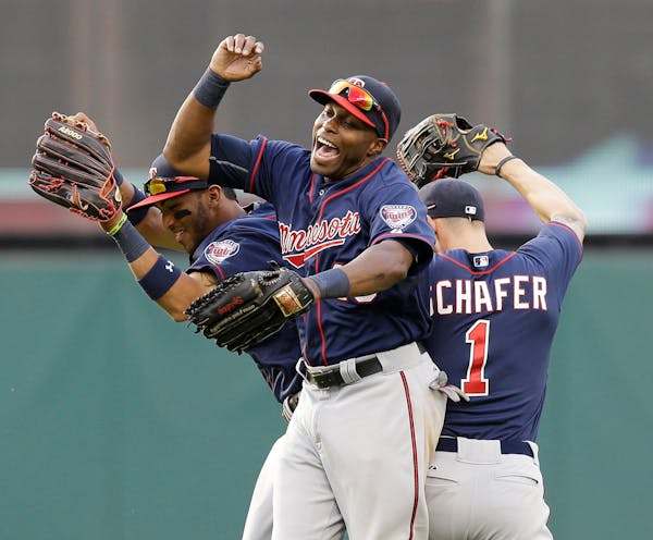 From left to right, Minnesota Twins' Eddie Rosario, Torii Hunter and Jordan Schafer celebrate after a 7-4 win over the Cleveland Indians in a baseball