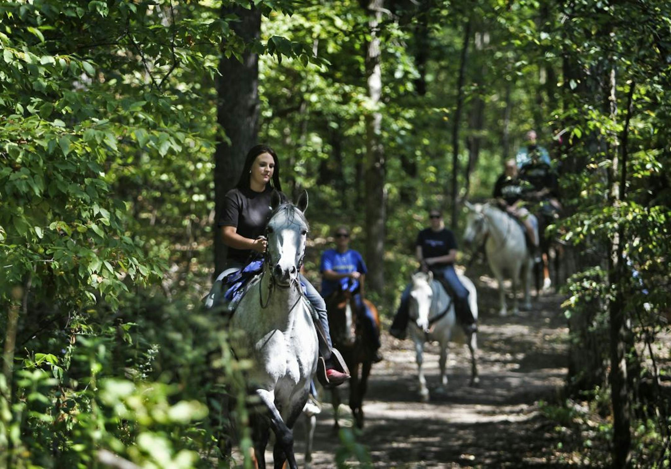 Amber Kiffmeyer led campers along a trail at Camp El Rancho Manana in Richmond, Minn.