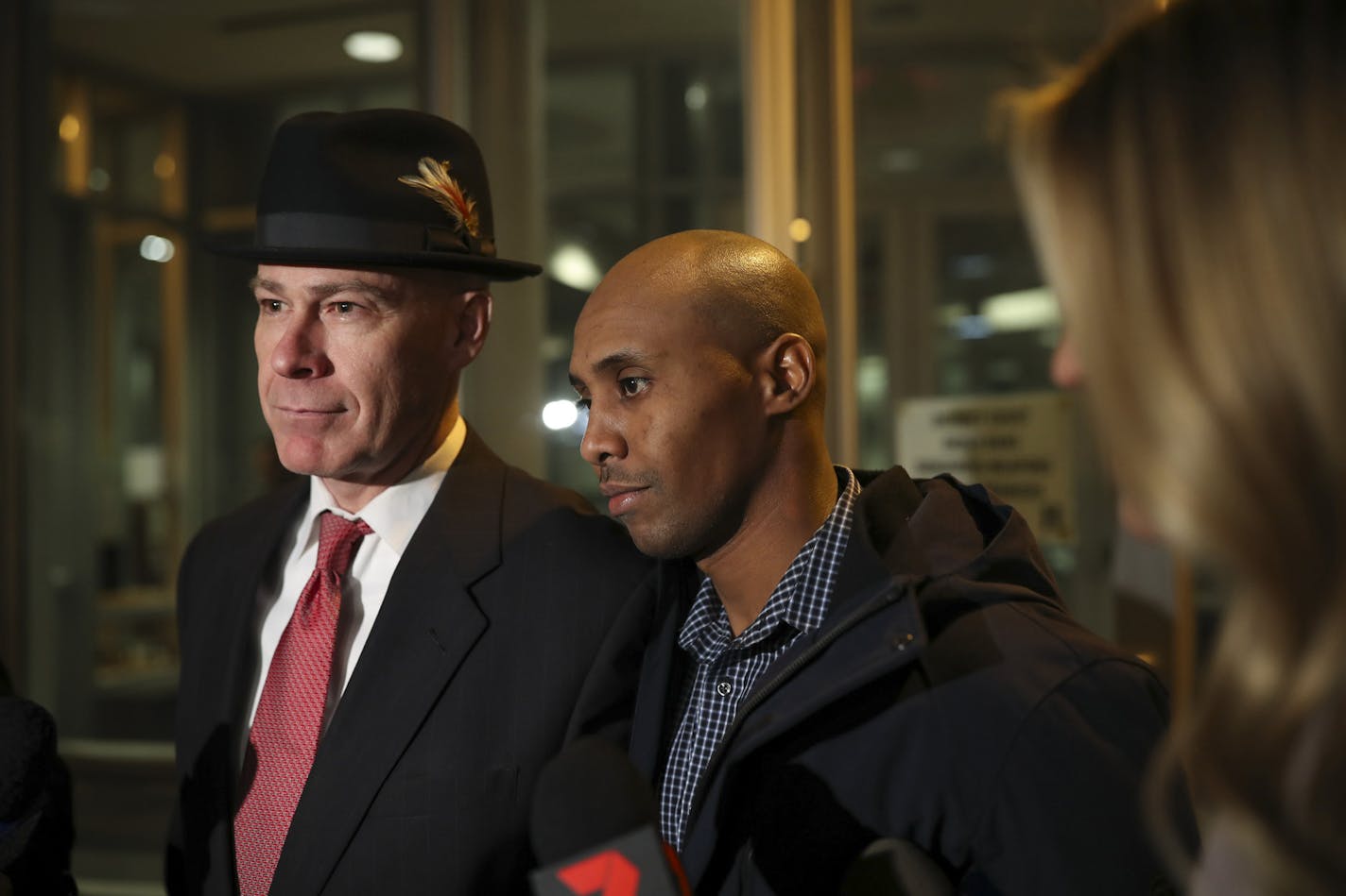 FILE -- Former Minneapolis Police Officer Mohamed Noor, middle, leaves the Hennepin County Public Safety Facility with his attorney, Thomas Plunkett, after posting bail on March 21, 2018, in Minneapolis.