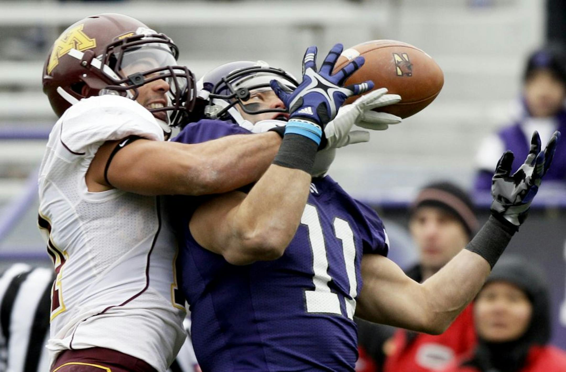 Northwestern wide receiver Jeremy Ebert (11) can't catch a touchdown pass against Minnesota defensive back Kyle Henderson (14) during the first half of an NCAA college football game, Saturday, Nov. 19, 2011, in Evanston, Ill.