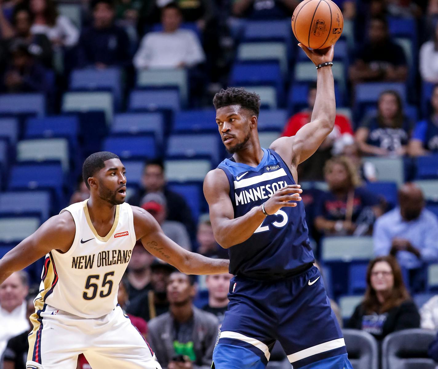 Minnesota Timberwolves guard Jimmy Butler (23) works against New Orleans Pelicans guard E'Twaun Moore (55) in the first half of an NBA basketball game in New Orleans, Wednesday, Nov. 1, 2017. (AP Photo/Scott Threlkeld)