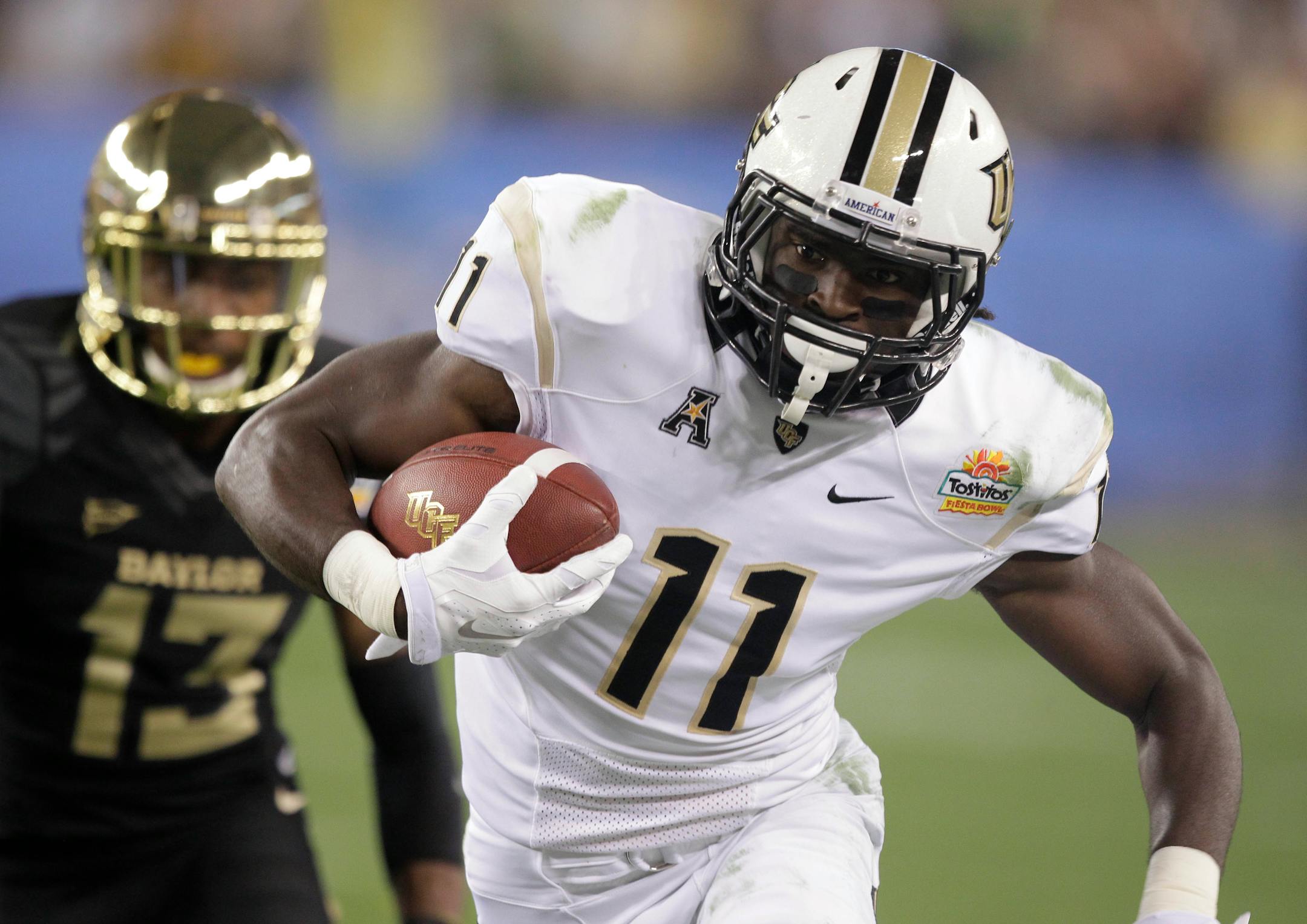 Central Florida wide receiver Breshad Perriman (11) makes a catch as Baylor safety Terrell Burt (13) pursues during the first half of the Fiesta Bowl NCAA college football game, Wednesday, Jan. 1, 2014, in Glendale, Ariz. (AP Photo/Rick Scuteri)