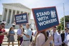 People gather at the Supreme Court awaiting a decision in an Illinois union dues case, Janus vs. AFSCME, in Washington, Monday, June 25, 2018. The out