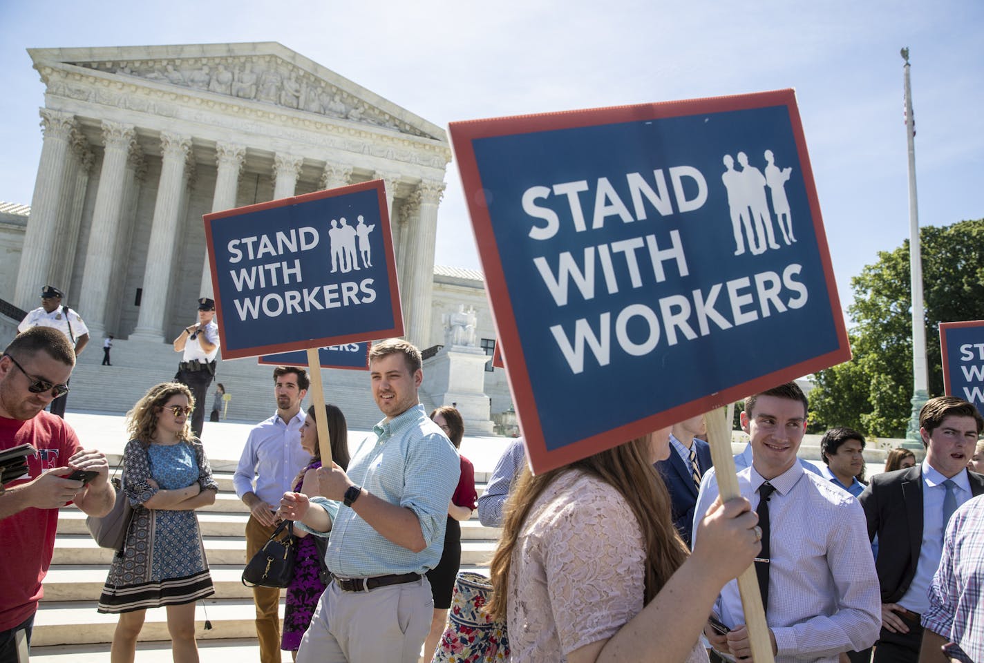 People gather at the Supreme Court awaiting a decision in an Illinois union dues case, Janus vs. AFSCME, in Washington, Monday, June 25, 2018. The outcome of that case and several others were not announced Monday as the court's term comes to a close. (AP Photo/J. Scott Applewhite)