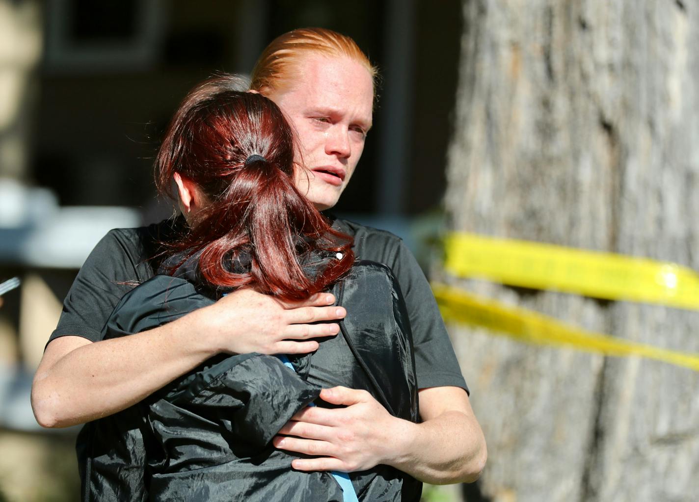 Jesse Lindstrom, facing camera, and his sister Jasmine Lindstrom, hug each other while waiting at the scene of the shooting. Police say a man and a baby are dead after what authorities are calling a "targeted" shooting in south Minneapolis.