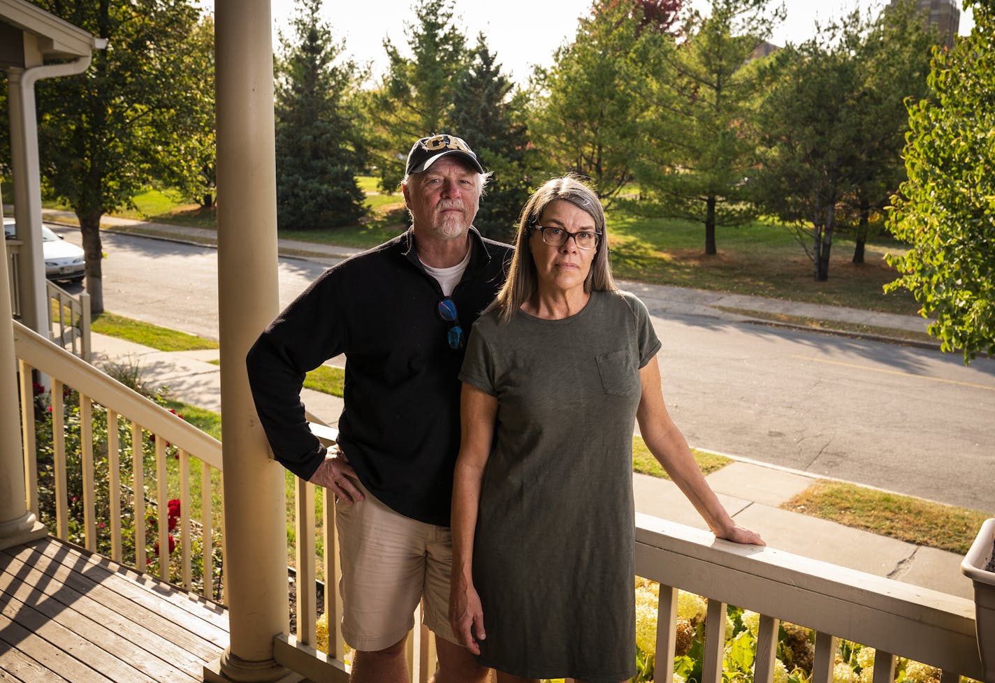 Lynne Snediker and her partner Richard Fuerstenberg, who live across the street from Bethesda Hospital, seen behind them, oppose turning the hospital into a shelter. ] LEILA NAVIDI • leila.navidi@startribune.com BACKGROUND INFORMATION: Lynne Snediker and her partner Richard Fuerstenberg live in a townhome across the street from Bethesda Hospital and oppose turning it into a shelter. Photographed in St. Paul on Friday, October 9, 2020.