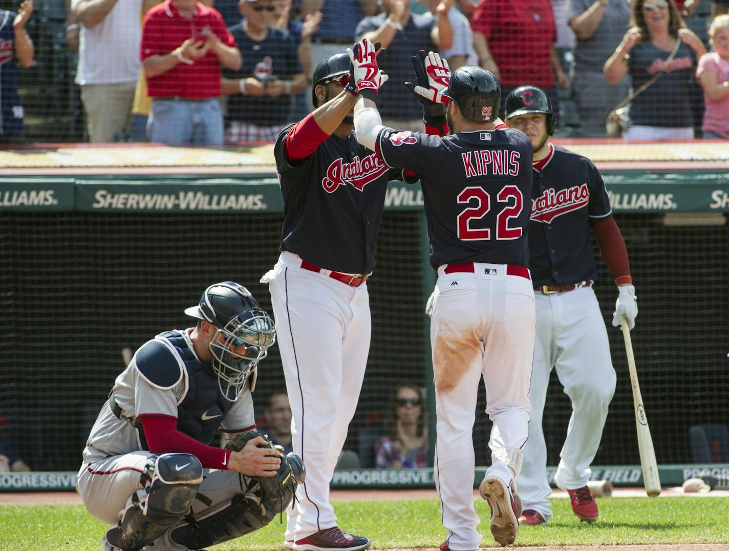 Jason Kipnis is greeted by Edwin Encarnacion and Roberto Perez after hitting a three-run home run as Twins catcher Mitch Garver looks away during the sixth inning