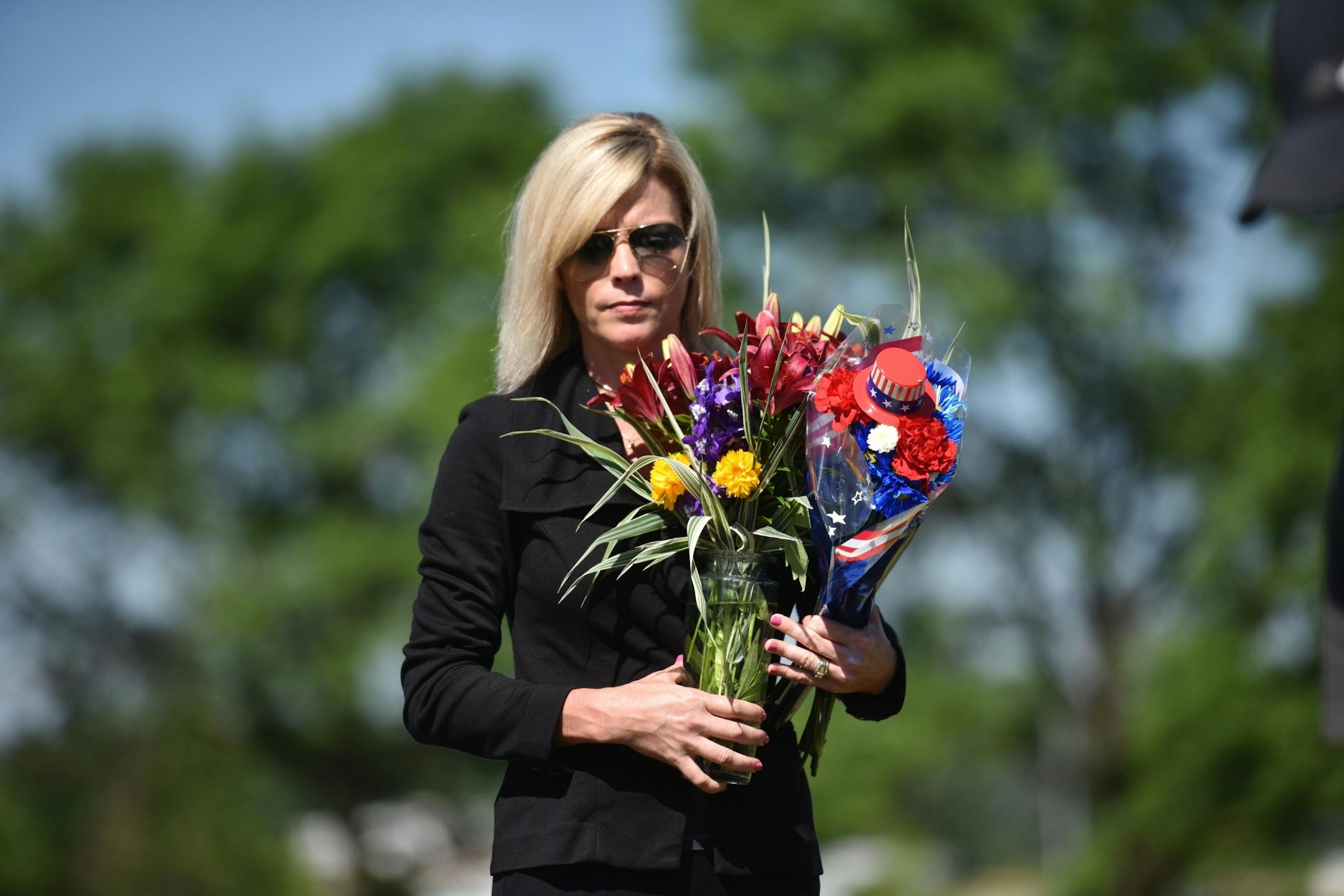 Mary Wise of the Wise Family Funeral Home held flowers as the man we put to rest.