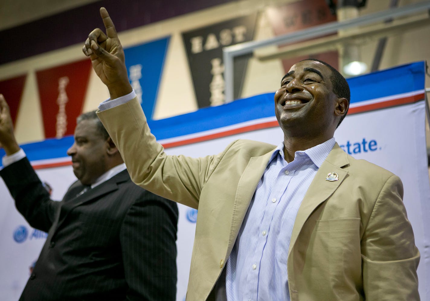 NFL Hall of Fame wide receiver Cris Carter, right, is joined by his older brother, Butch Carter, in singing the Middletown (OH) High School fight song during an honor ceremony for Cris Carter at the high school gymnasium May 7, 2013. Carter will be inducted into the NFL Hall of Fame in August, and was visiting his boyhood home.