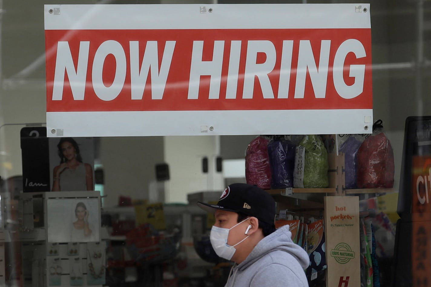 File photo shows a man wearing a mask while walking under a Now Hiring sign at a CVS Pharmacy during the coronavirus outbreak in San Francisco.