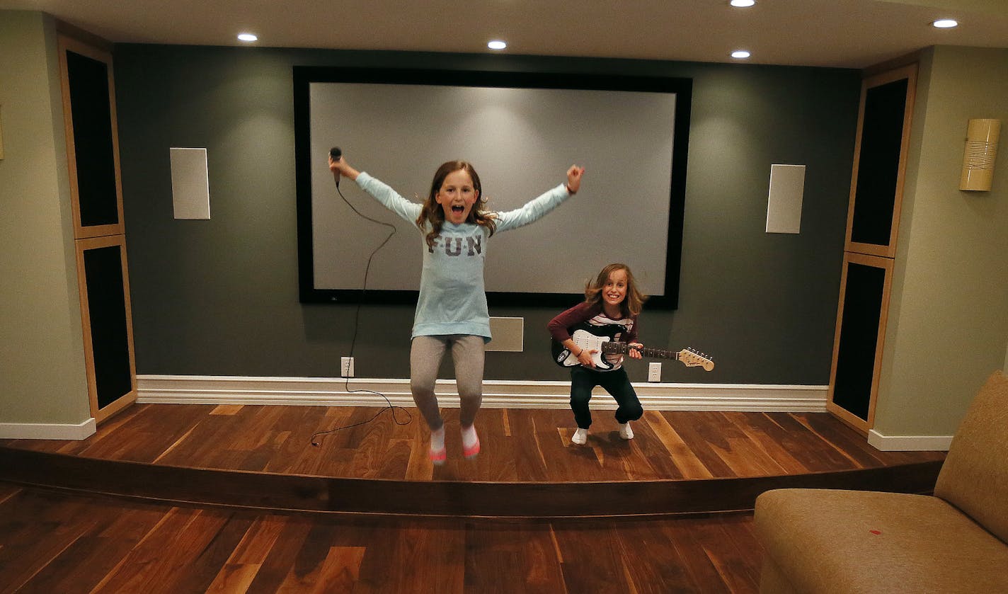 Twins Noa left and Maya Mor enjoyed the stage in finished family room of the lower level of there home Thursday October 30 , 2014 in Minnetonka ,MN. ] Jerry Holt Jerry.holt@startribune.com