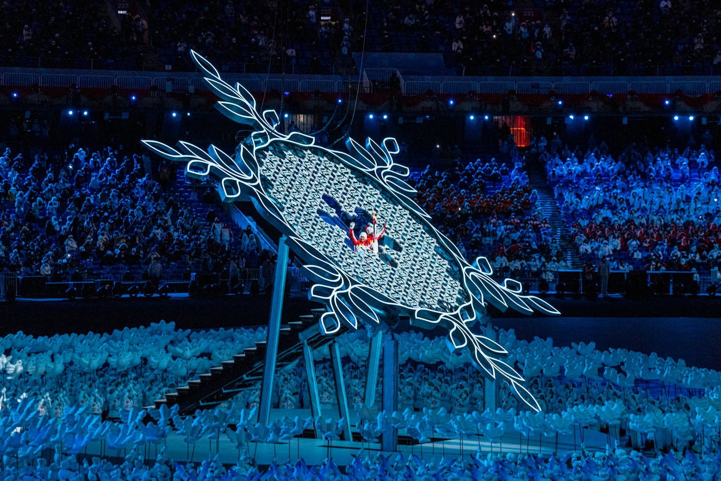 Torch bearers Dinigeer Yilamujiang, left, and Jiawen Zhao of China, light the Olympic cauldron during the opening ceremony of the 2022 Beijing Olympics in Beijing on Friday, Feb. 4, 2022. In a climactic moment to end the opening ceremony of the 2022 Winter Olympics, China chose two athletes - including Yilamujiang it said was of Uyghur heritage - to deliver the flame to the Olympic cauldron and officially start the Games. Yilamujiang, a cross-country skier who the Chinese said has Uyghur roots, confronted head-on one of the biggest criticisms of the country's role as host. (Hiroko Masuike/The New York Times)