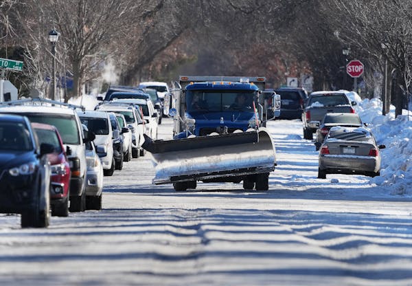 A snowplow navigated crowded Charles Avenue, covered with snow and ice, near Grotto Street in St. Paul in January.