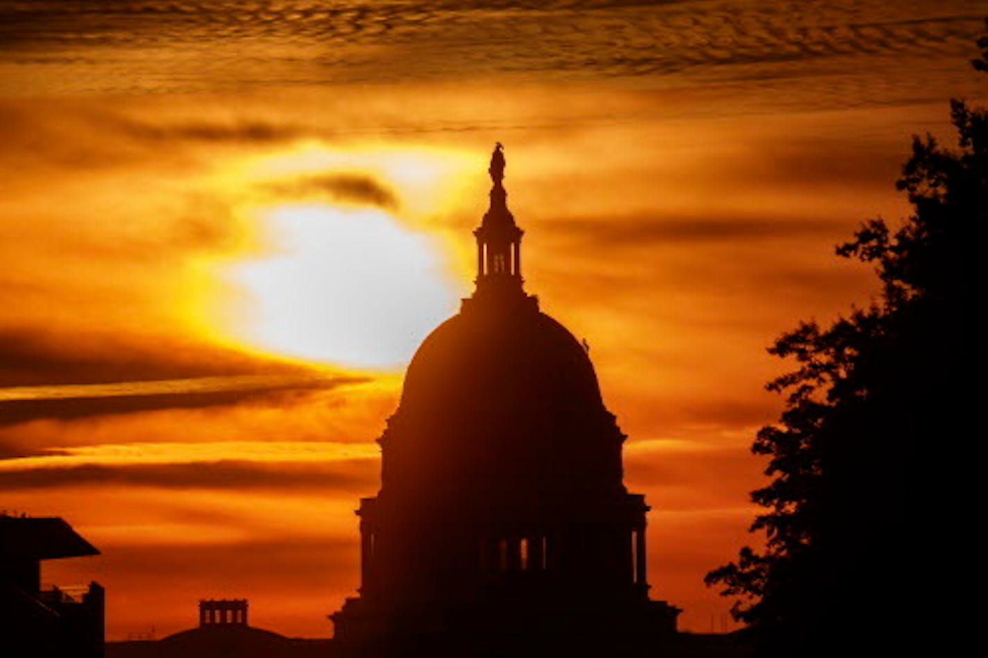 In this Oct. 26, 2018, file photo the rising sun silhouettes the U.S. Capitol dome at daybreak in Washington. The Treasury Department said Tuesday that the U.S. reported a $100.5 billion deficit in October.