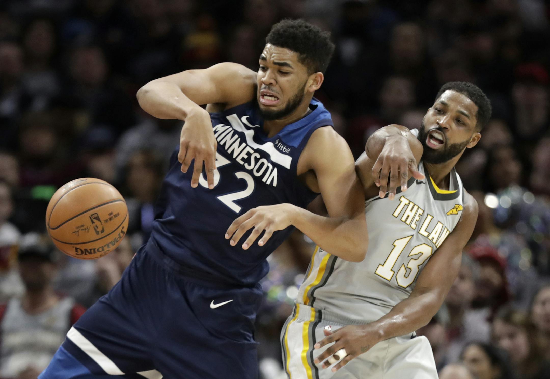 Minnesota Timberwolves' Karl-Anthony Towns (32) and Cleveland Cavaliers' Tristan Thompson (13) battle for a rebound in the second half of an NBA basketball game, Wednesday, Feb. 7, 2018, in Cleveland. The Cavaliers won 140-138 in overtime. (AP Photo/Tony Dejak)