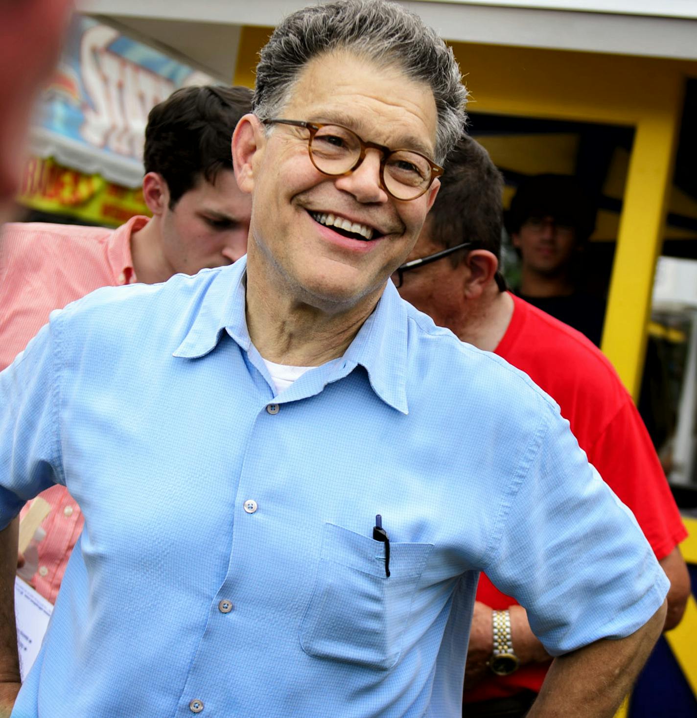 DFL Senator Al Franken handed out fans with his smiling image on them and greeted supporters in front of his booth Thursday morning at the first day of the State Fair. ] FALCON HEIGHTS, MN -- Thursday, August 21, 2014. GLEN STUBBE * gstubbe@startribune.com