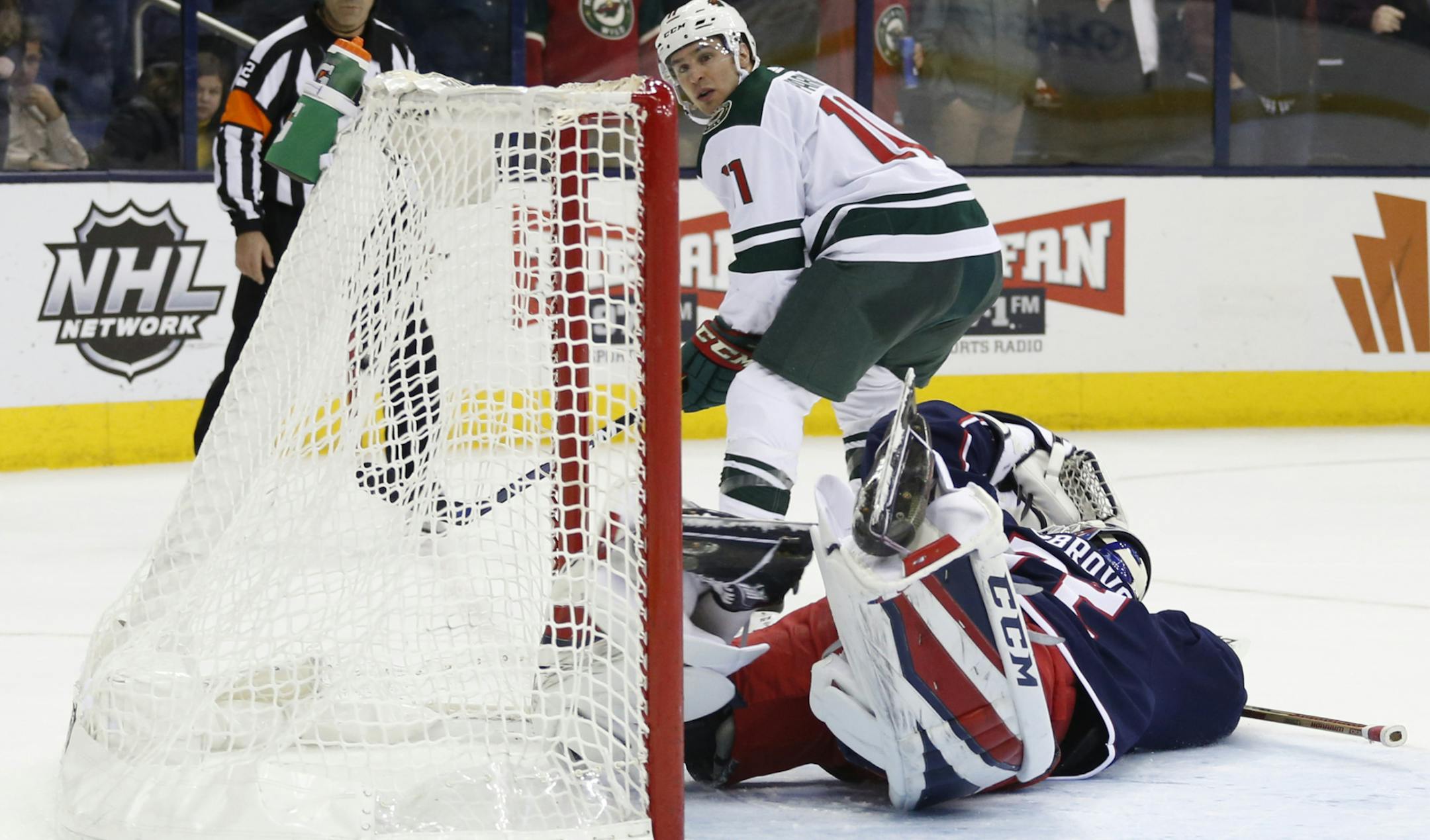 Minnesota Wild's Zach Parise, top, watches his shot go in past Columbus Blue Jackets' Sergei Bobrovsky, of Russia, during the shootout period of an NHL hockey game Tuesday, Jan. 30, 2018, in Columbus, Ohio. The Wild beat the Blue Jackets 3-2 in a shootout. (AP Photo/Jay LaPrete)