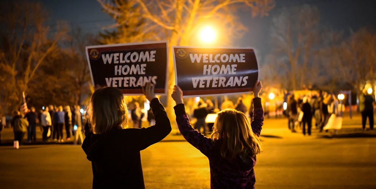 Friends Olivia Bremer, left, and Skylar Bouman, both 9, of Waconia, waved signs in support of the more than 140 veterans who took part in a whirlwind trip to Washington, D.C. Wednesday to visit war memorials. ] AARON LAVINSKY &#xef; aaron.lavinsky@startribune.com Carver County veterans and charity groups raised nearly $100,000 to send 143 Korean and Vietnam war vets on an honor trip to Washington, D.C., to tour the war memorials. When they arrived home Wednesday night after whirlwind 16-hour tri